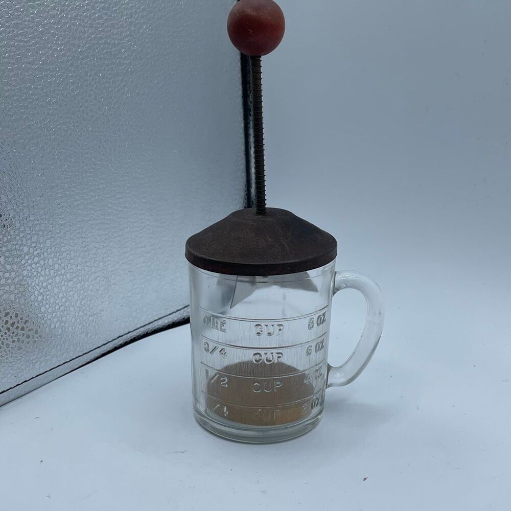 Vintage food nut chopper in measuring cup. Hazel Atlas?